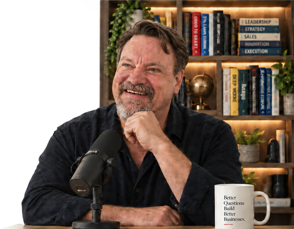 Peter Holgate seated at a podcast microphone in a warm studio library, smiling with his hand at his chin